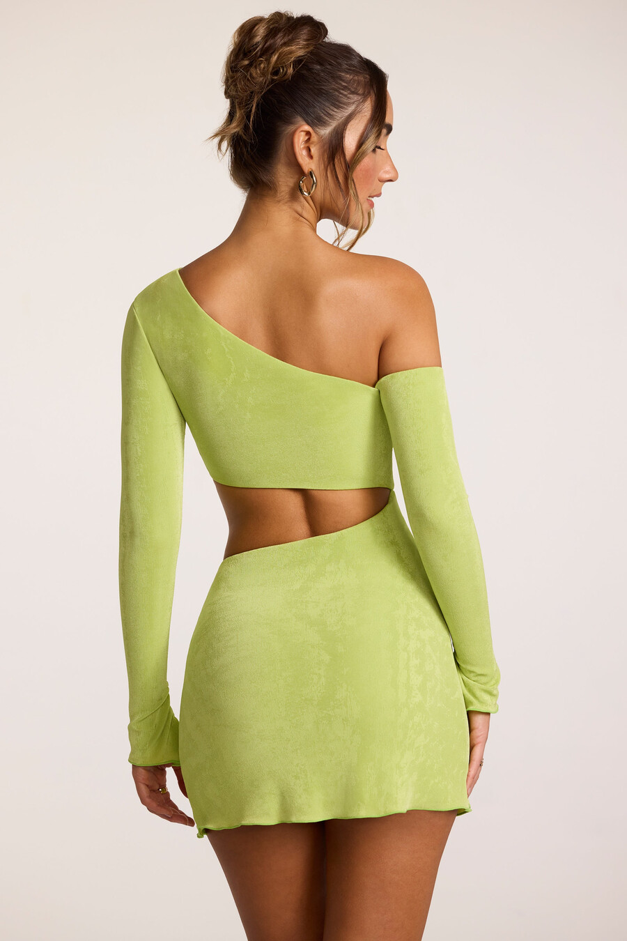 mini-jurk met asymmetrische uitsnijdingen van gestructureerde jersey in limoengroen.