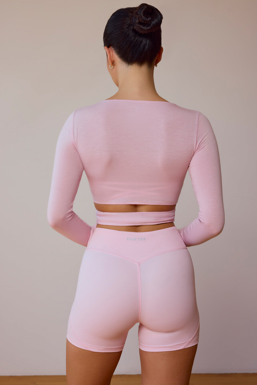 crop top met lange mouwen en wikkeldetail in zachtroze